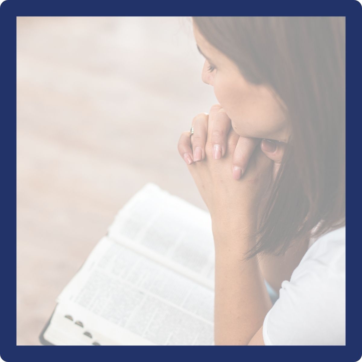 woman with Bible praying